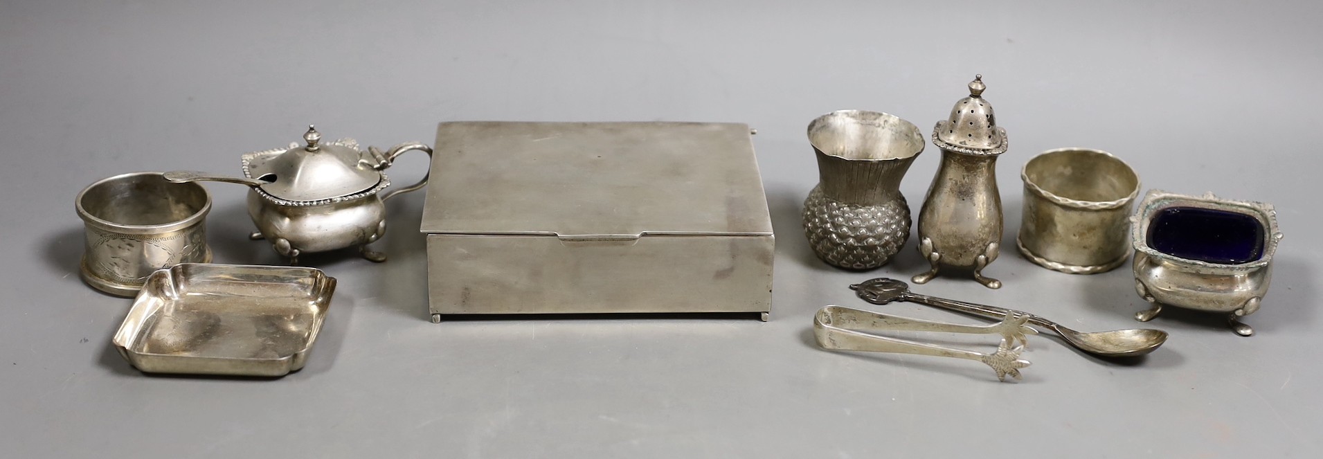 A George V silver mounted cigarette box, 11.5cm and other small sundry silver and plated items including napkin rings, condiments and small dish.